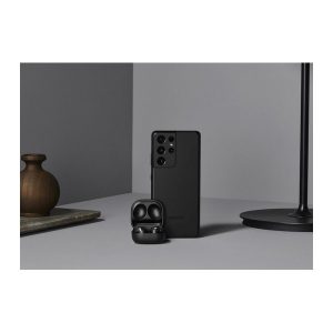 Samsung Galaxy S21 Ultra 5G in black, back facing out, standing beside an open earbuds case